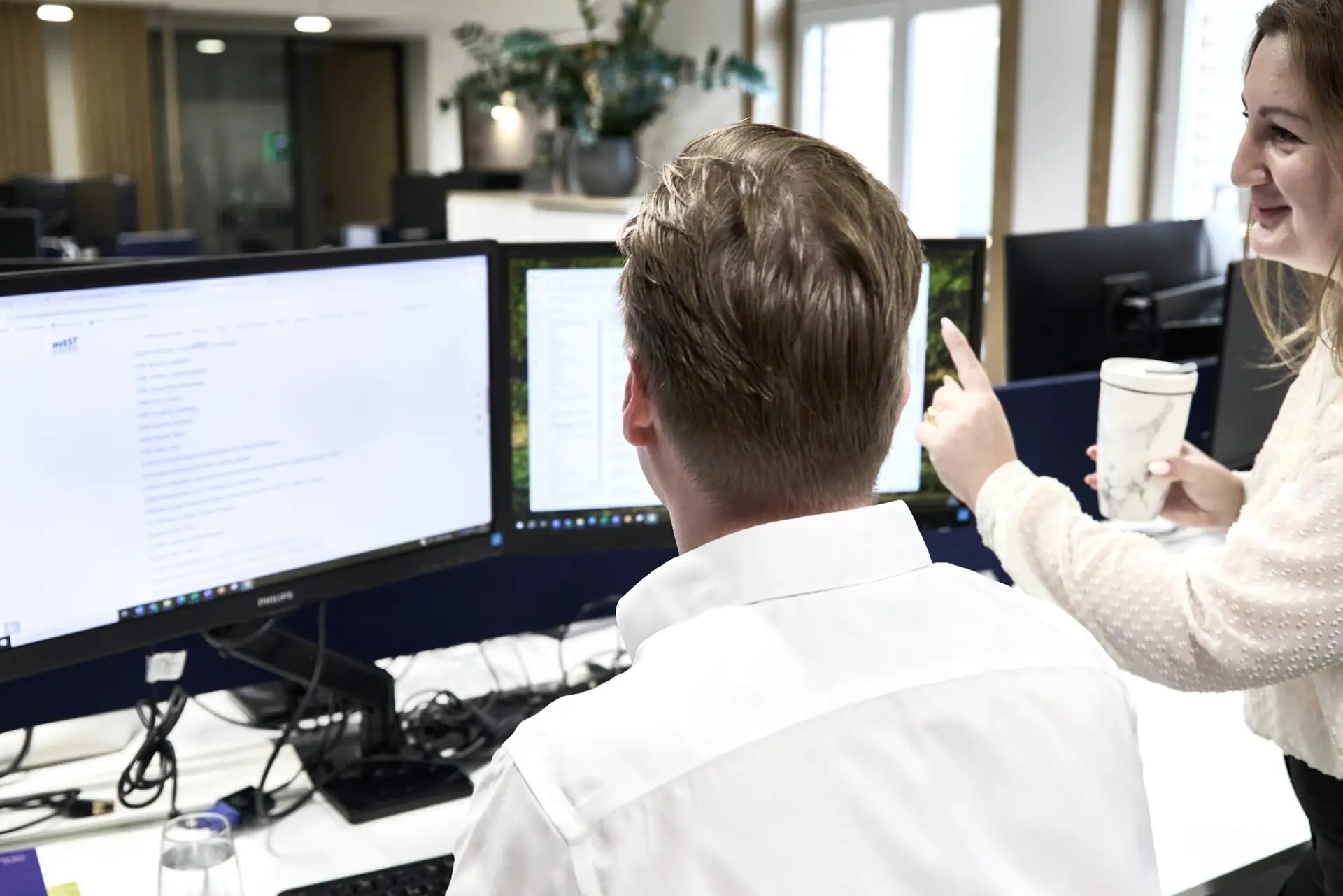 A finance team going through figures together on a screen